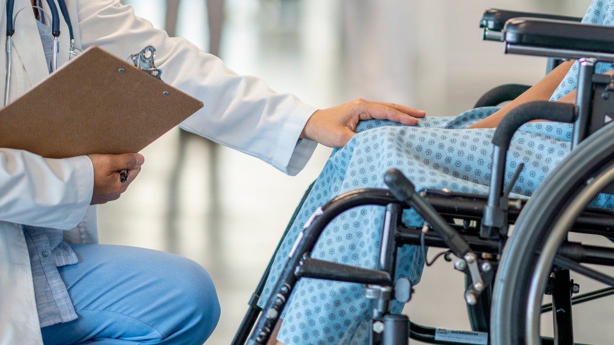 Doctor with patient in wheelchair