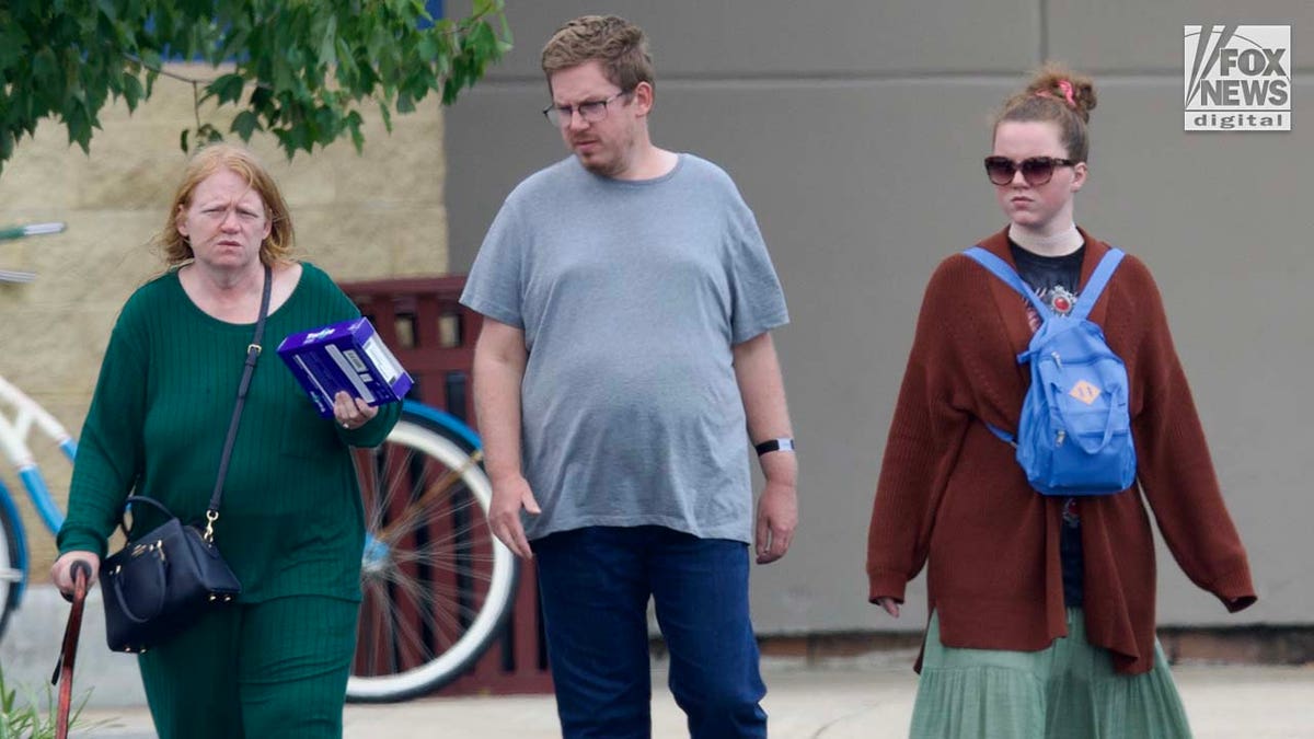 Rex Heuermann's wife, Asa Ellerup and daughter, Victoria Heuermann walk on the street