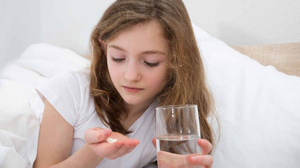 Young girl taking medication