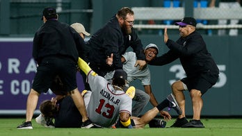 Braves' Ronald Acuña Jr knocked over in wild scene at Coors Field as security wrestles fans wanting hug