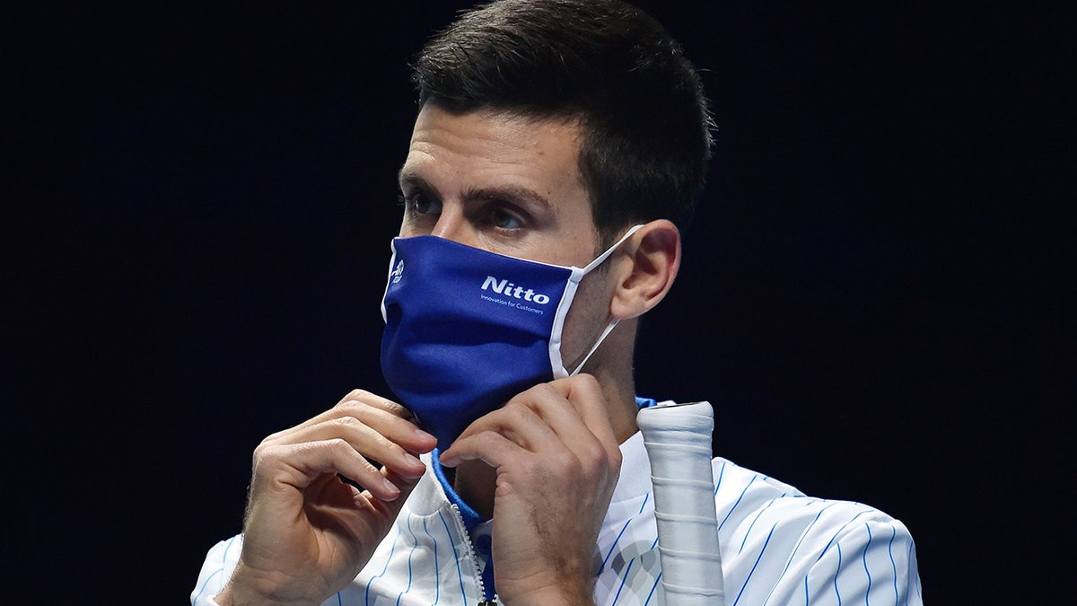 Novak Djokovic wears a mask