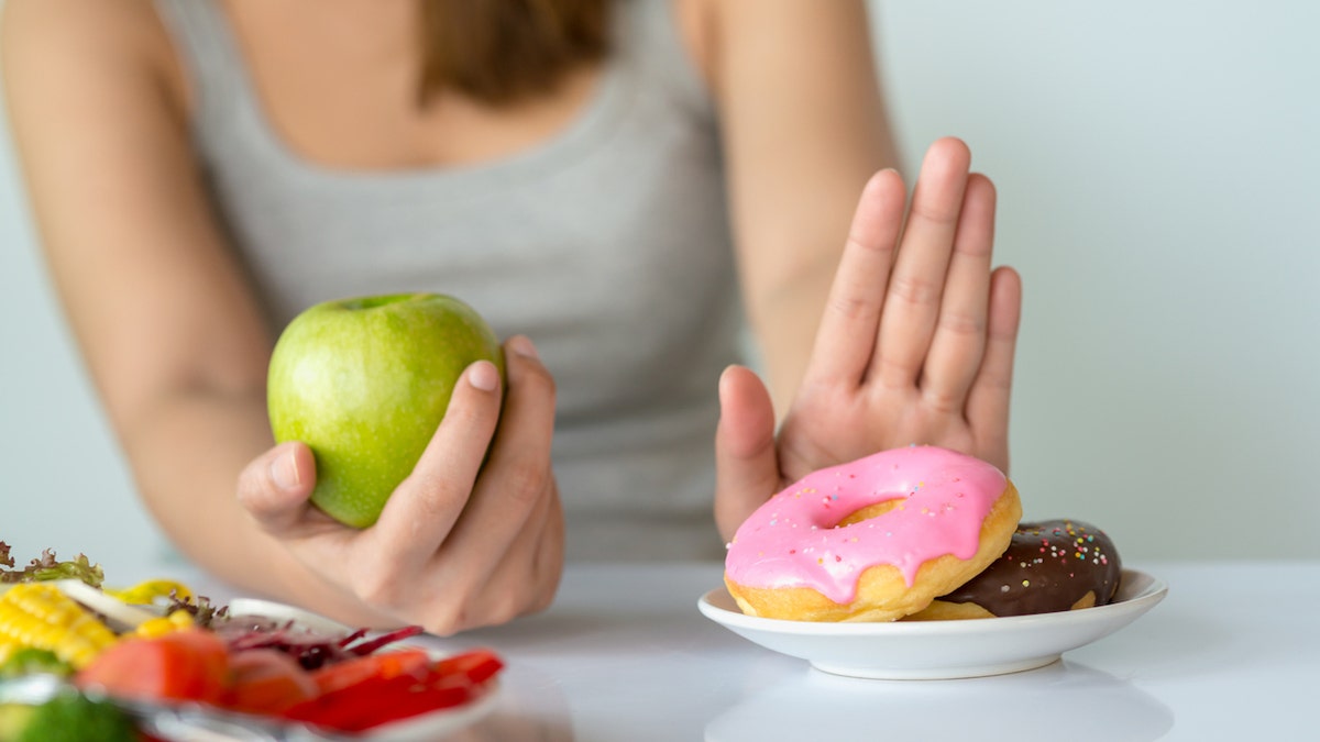 Woman pushing away junk food