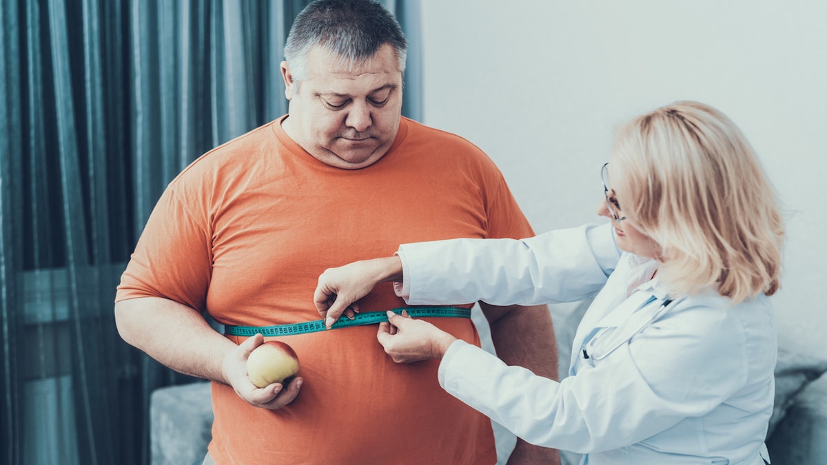 Obese man with doctor