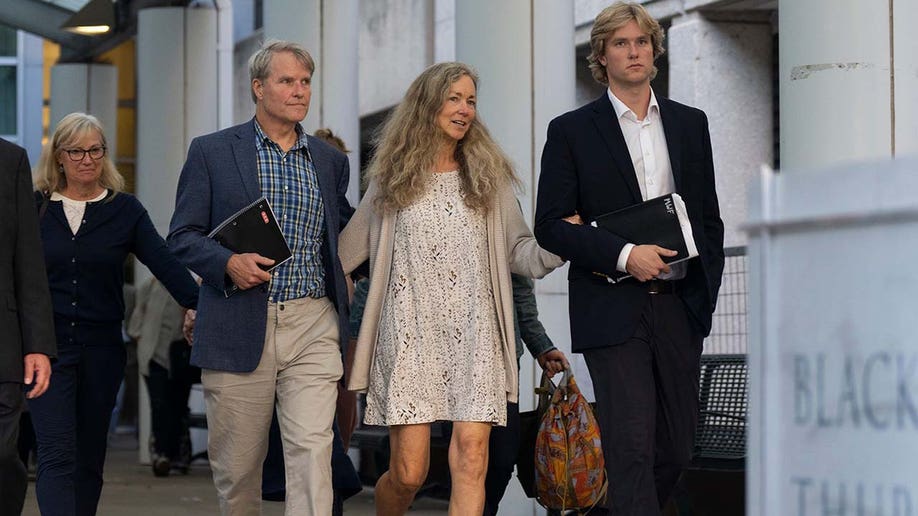 ric Wilson, Karen Wilson and Matt Wilson walk toward a press conference