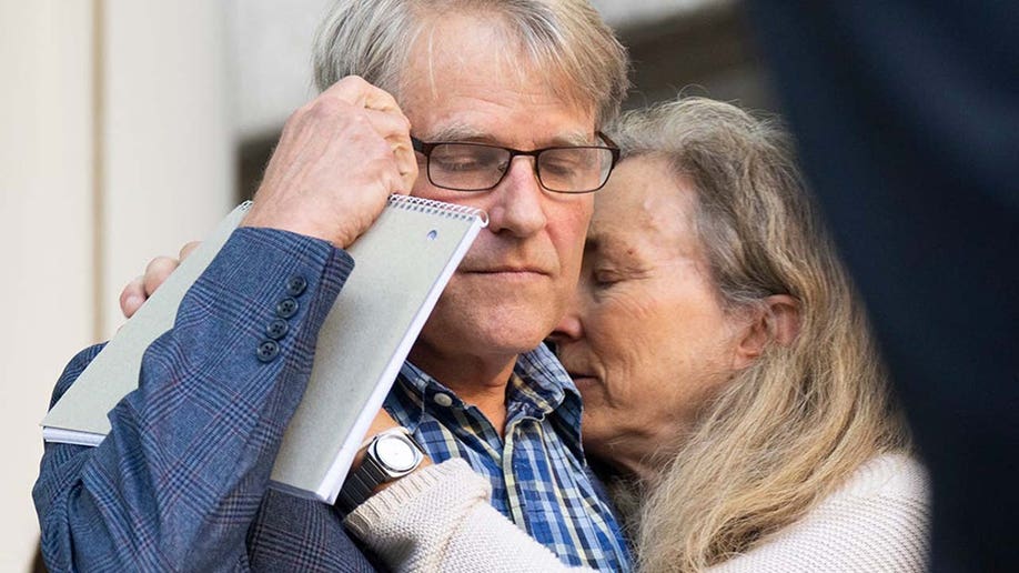 Eric and Karen Wilson, embrace after a press conference following the sentencing of Kaitlin Armstrong