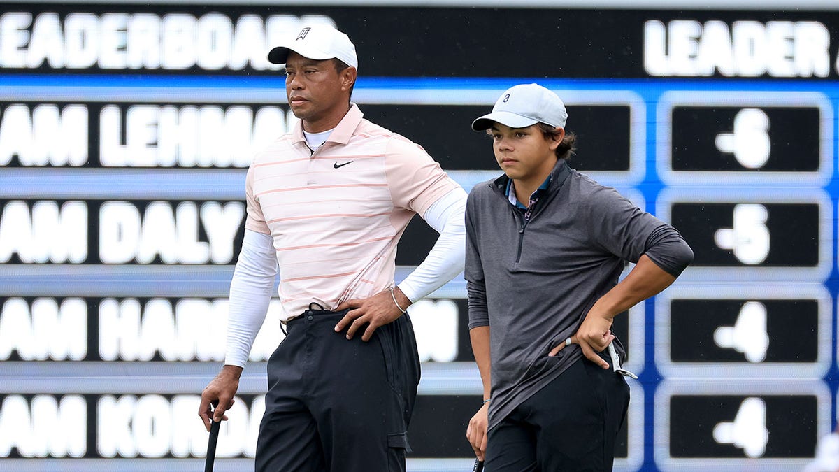 Tiger Woods of The United States, left, and his son Charlie Woods wait to putt on the ninth hole standing in a similar fashion during the first round of the PNC Championship at The Ritz-Carlton Golf Club on Dec. 16, 2023 in Orlando, Florida.