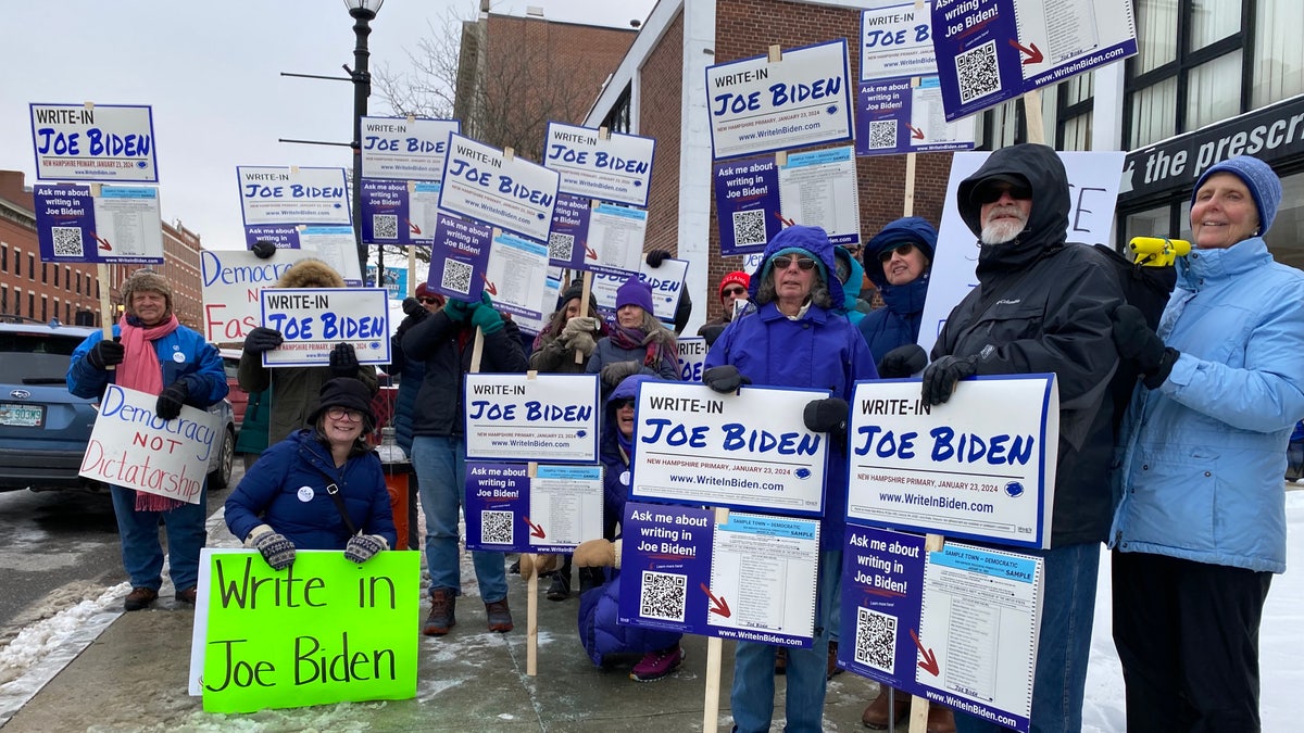 Supporters of the "Write-In Joe Biden" effort in the New Hampshire primary stand for a photo on Jan. 19, 2024 in Concord, New Hampshire.