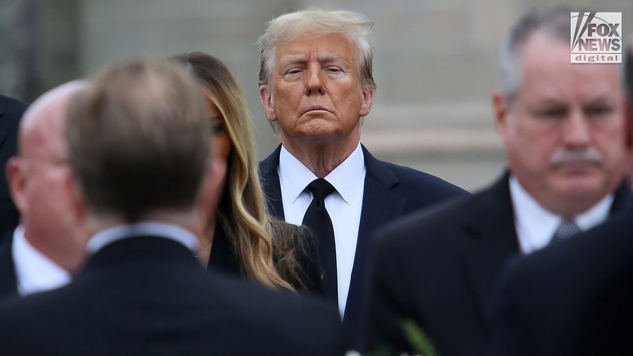 Former President Donald Trump looks on alongside his wife Melania, son Barron, and father-in-law Viktor Knavs as the coffin carrying the remains of the former First Lady’s mother Amalija Knavs is carried into the Church of Bethesda-by-the-Sea