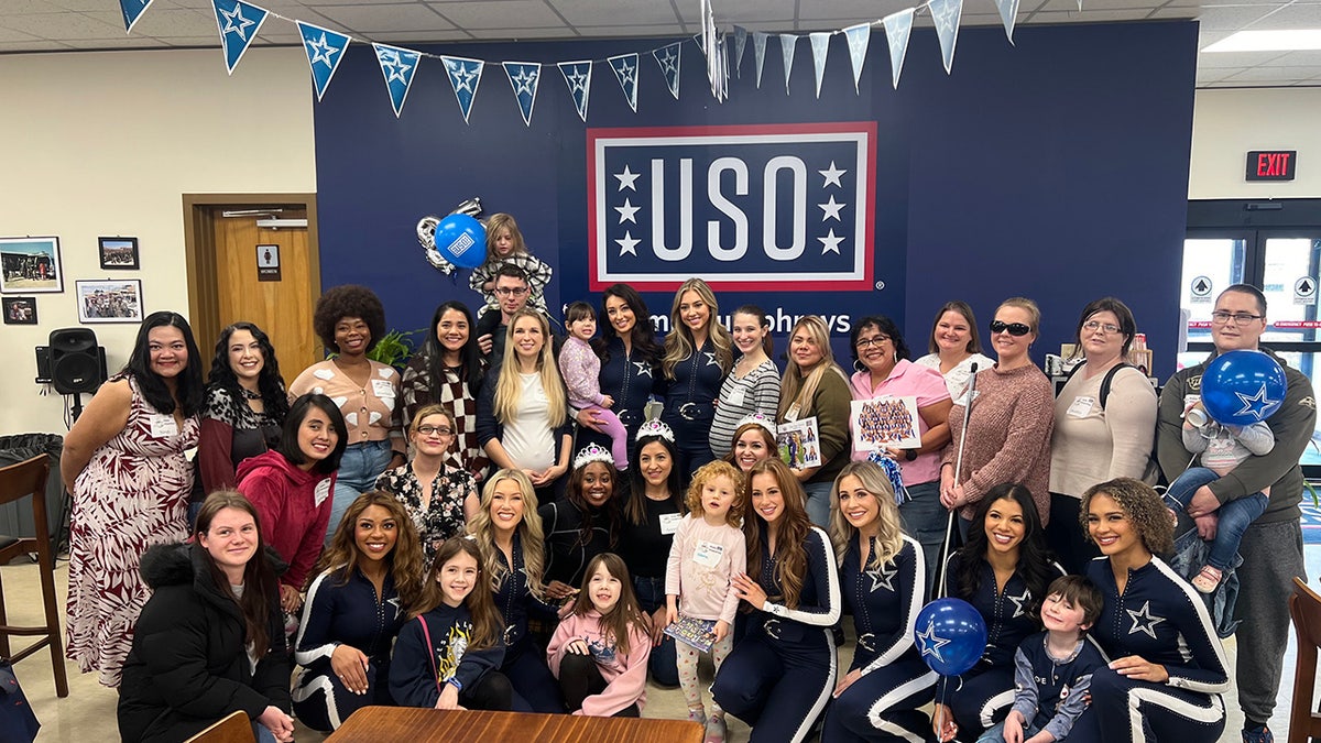 A group of the Dallas Cowboys Cheerleaders visiting with families of U.S. troops