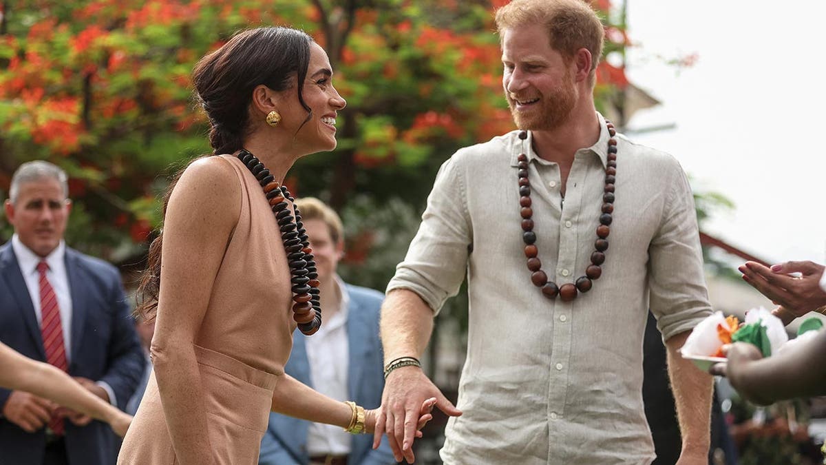 Prince Harry and Meghan are feted in a school in Nigeria