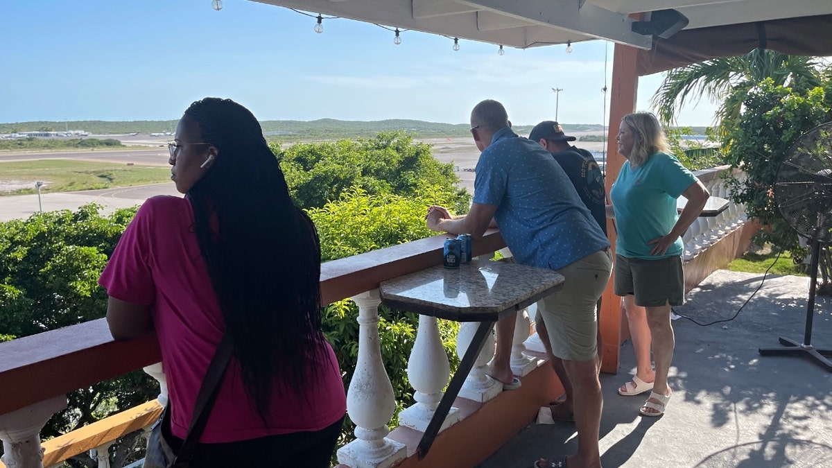 Grier, Hagerich, Watson and Watson's mother look out onto an island vista.