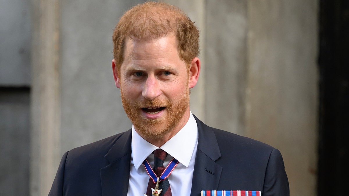 Prince Harry looks to his left while out in London