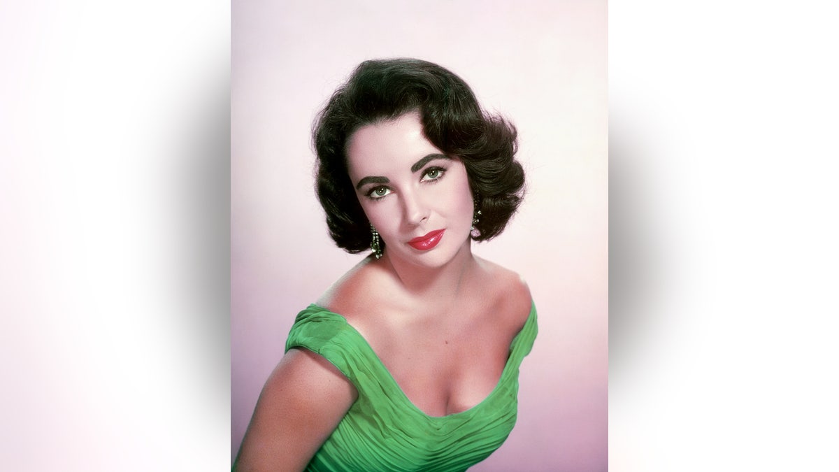 Elizabeth Taylor wearing a green dress.