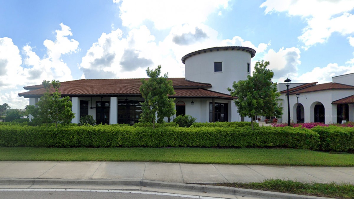 PELICAN LARRYS exterior, white stucco building with round tower, clay tile roof