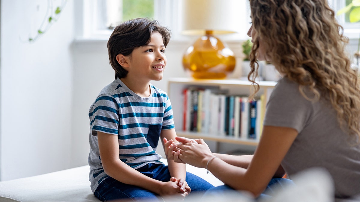 boy talking to his mother at home 