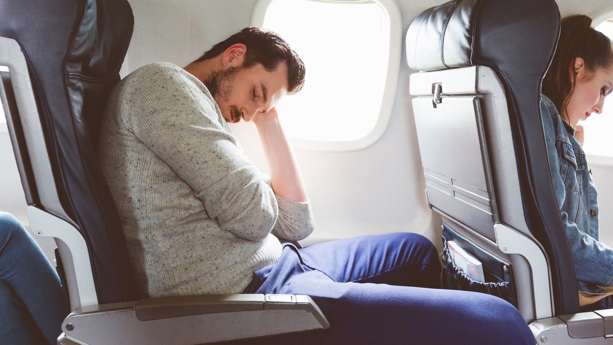 Man sleeping on plane