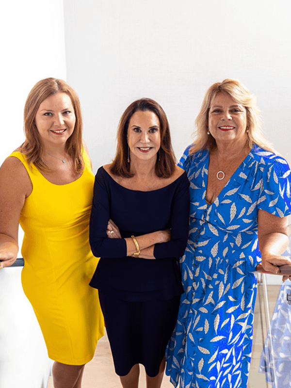 three professional looking women posing for a photo together