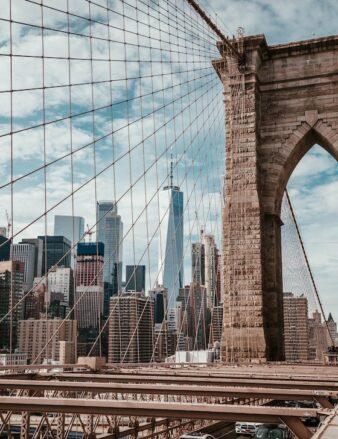 a photo of a bridge with Manhattan in the background