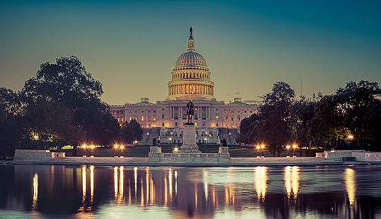 Panoramic image of the Capitol of the United States with the capitol reflecting pool in morning light.