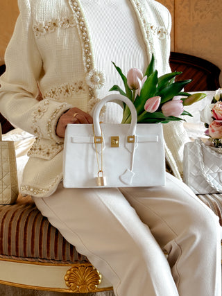 Victoria Handbag Resin Vase placed on a woman's lap.