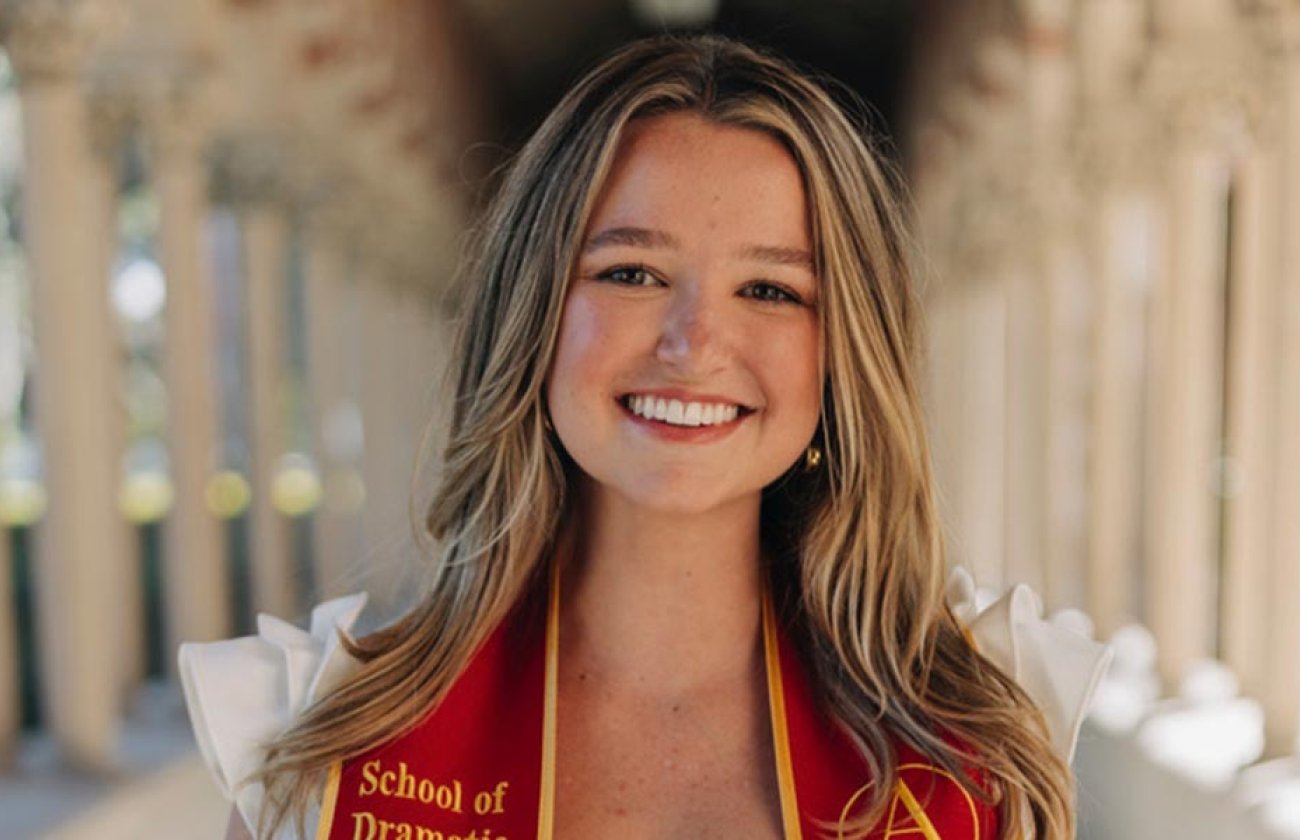 Tess Patton smiles for camera wearing USC graduation stole