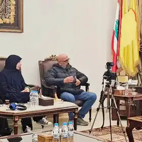 The Subeiti sisters Fatima (far left) and Batool (second from left) shared an image of their meeting with Hezbollah leader Muhammed Raad (right). They blurred out the Hezbollah logo on the yellow flag and used astrixes when writing the name of the terror group (Photo: Instagram)