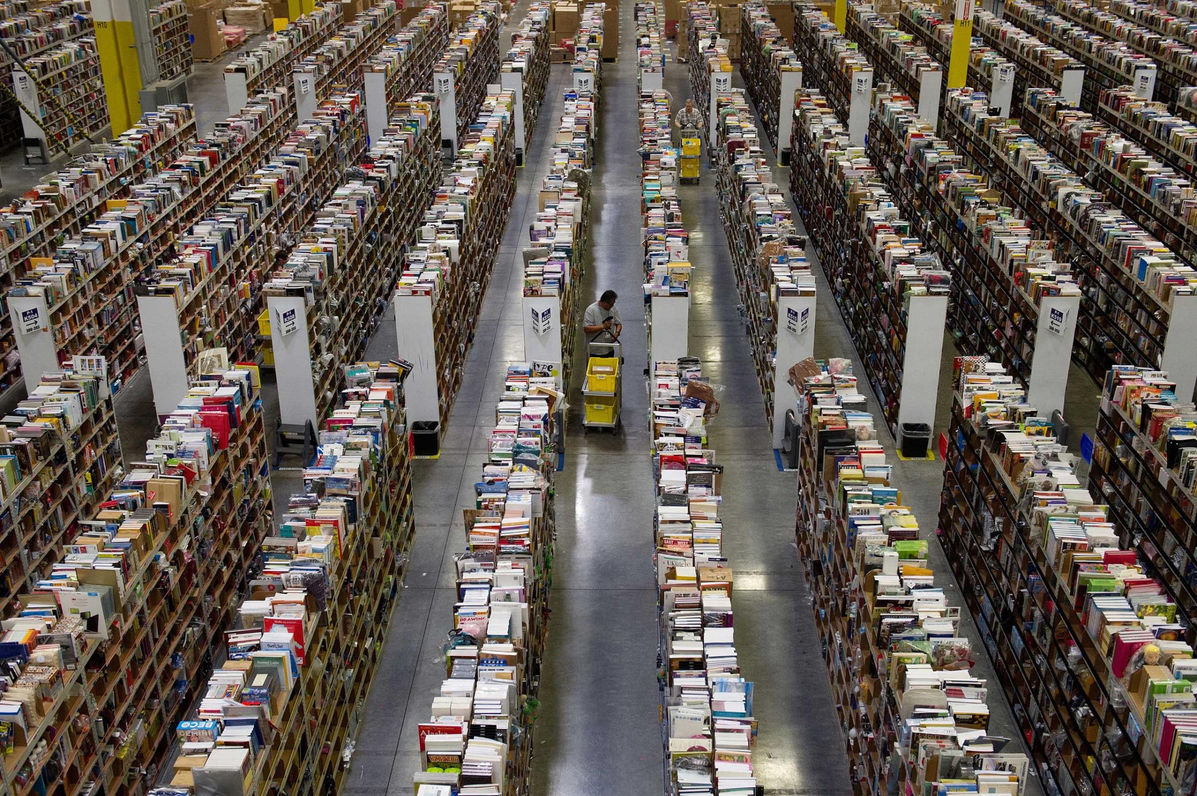 Employees collect merchandise ordered by customers for shipment from the Amazon.com distribution center in Phoenix, Arizona, Nov. 26, 2012.