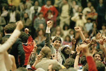 FILE - In this April 4, 1983, file photo, North Carolina State coach Jim Valvano, center with fist raised, celebrates after his basketball team defeat