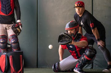 Tucker Frawley, minor league infield and catching coordinator for the Twins, gave pointers to catcher Brian O'Keefe on Thursday in Fort Myers, Fla.