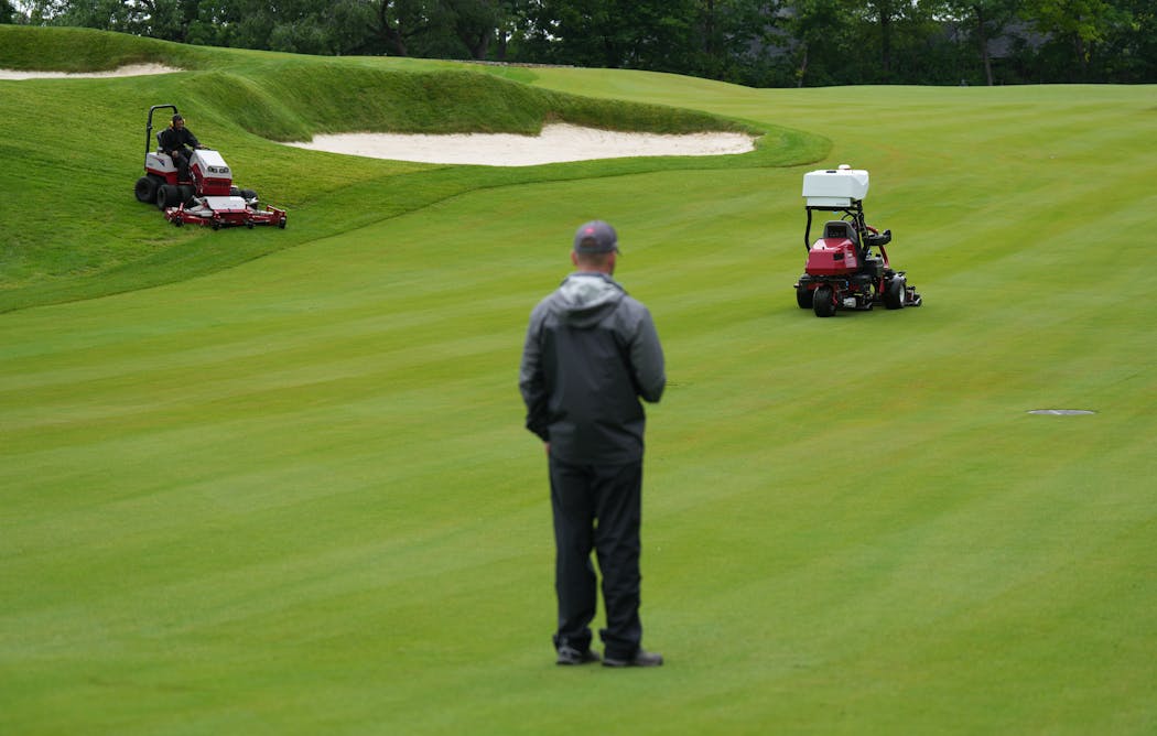 Josh Kravik, Toro’s global product marketing manager, demonstrates the capability of Toro’s autonomous fairway mower at Interlachen Country Club. Humans still need to operate mowers on the rough.  