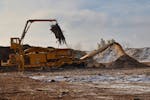 An industrial shredder turns tree scraps into biomass fuel for District Energy in St. Paul. The 12-acre wood yard near Pig’s Eye Lake is one of the 