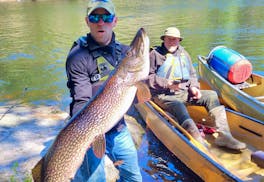 Jake Skarloken, left, with his monster northern pike. He released the fish.