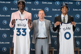 Minnesota Timbwerwloves General Manger Tim Connelly (center) posed with draft picks Leonard Miller left and Jaylen Clark Monday June 26,2023 in Minnea