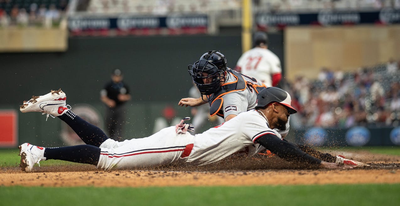 The Twins' Byron Buxton slides home just ahead of Tigers catcher Jake Rogers' tag, giving the Twins a 4-3 lead in the seventh inning of an eventual 5-