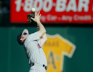 Twins second baseman Denny Hocking pulls down the final out of the 2002 Division Series with the A's, securing a 5-4 victory at Oakland and advancing 