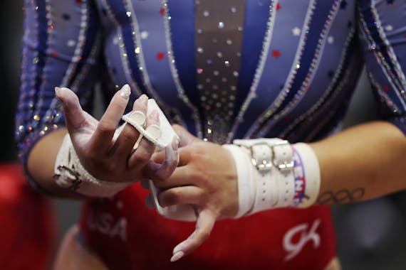 Suni Lee gets ready to compete on the uneven bars on Day 2 of the U.S. gymnastics Olympic trials at Target Center in Minneapolis on Sunday.