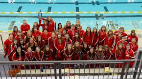 The members of Stillwater's synchronized swimming team pose with their trophy from the state championships.