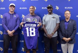 Mark Wilf, right, joined Vikings coach Kevin O'Connell, left, Justin Jefferson and General Manager Kwesi Adofo-Mensah on stage Tuesday in Eagan after 