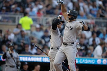 Yankees designated hitter Giancarlo Stanton, right, celebrates his third-inning solo homer with teammate Anthony Rizzo against the Twins on Tuesday ni