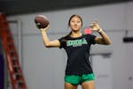 Edina senior Kaylee Idrogo-Lam passes the football during the Edina girls flag football practice at TCO Performance Center on Friday.