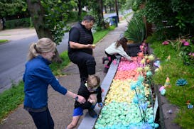 Jenny and Kyle Mekemson and their children Graham and Clara find some of their favorite rocks in their Kindness Rock Garden.