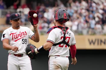 Twins closer Jhoan Duran celebrates with catcher Ryan Jeffers after pitching a 1-2-3 ninth to earn a save in Saturday's 5-3 victory over the Rangers a