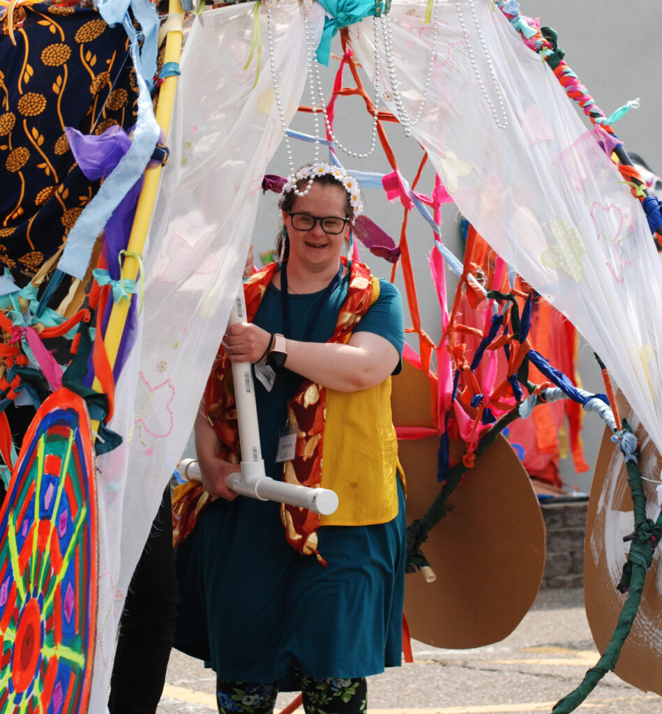 Interact Center for the Visual and Performing Arts. Interact artist Briana puppeteering her large-scale art based on "The Chariot" tarot card.