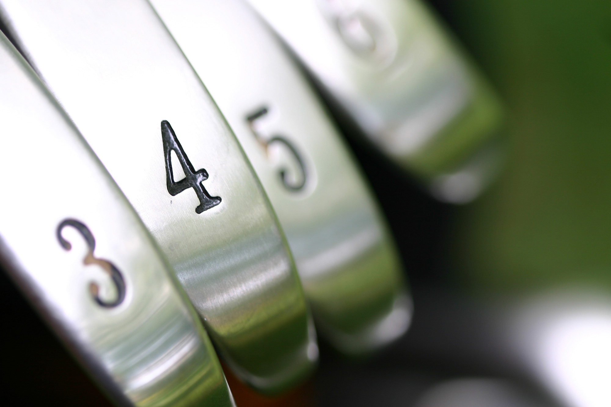 Closeup of golf clubs including the 3, 4, 5 and 6 irons.