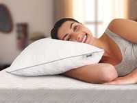 A woman laying on the Sealy Adjustable pillow