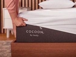 Woman placing cover on Cocoon mattress