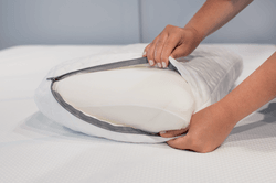 The  washable cover being removed from a Tempur-Cloud pillow