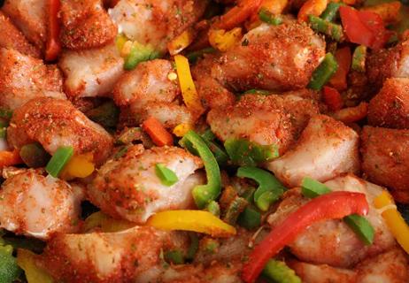 Seasoned chicken chunks with green and red peppers