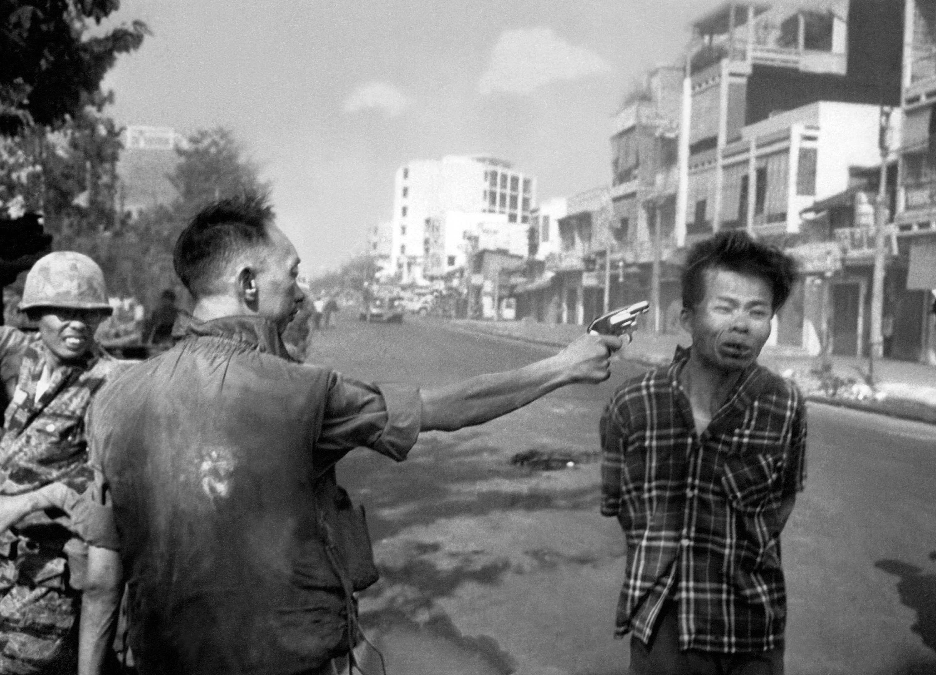 In this Feb. 1, 1968, file photo, South Vietnamese Gen. Nguyen Ngoc Loan, chief of the National Police, fires his pistol into the head of suspected Viet Cong officer Nguyen Van Lem (also known as Bay Lop) on a Saigon street