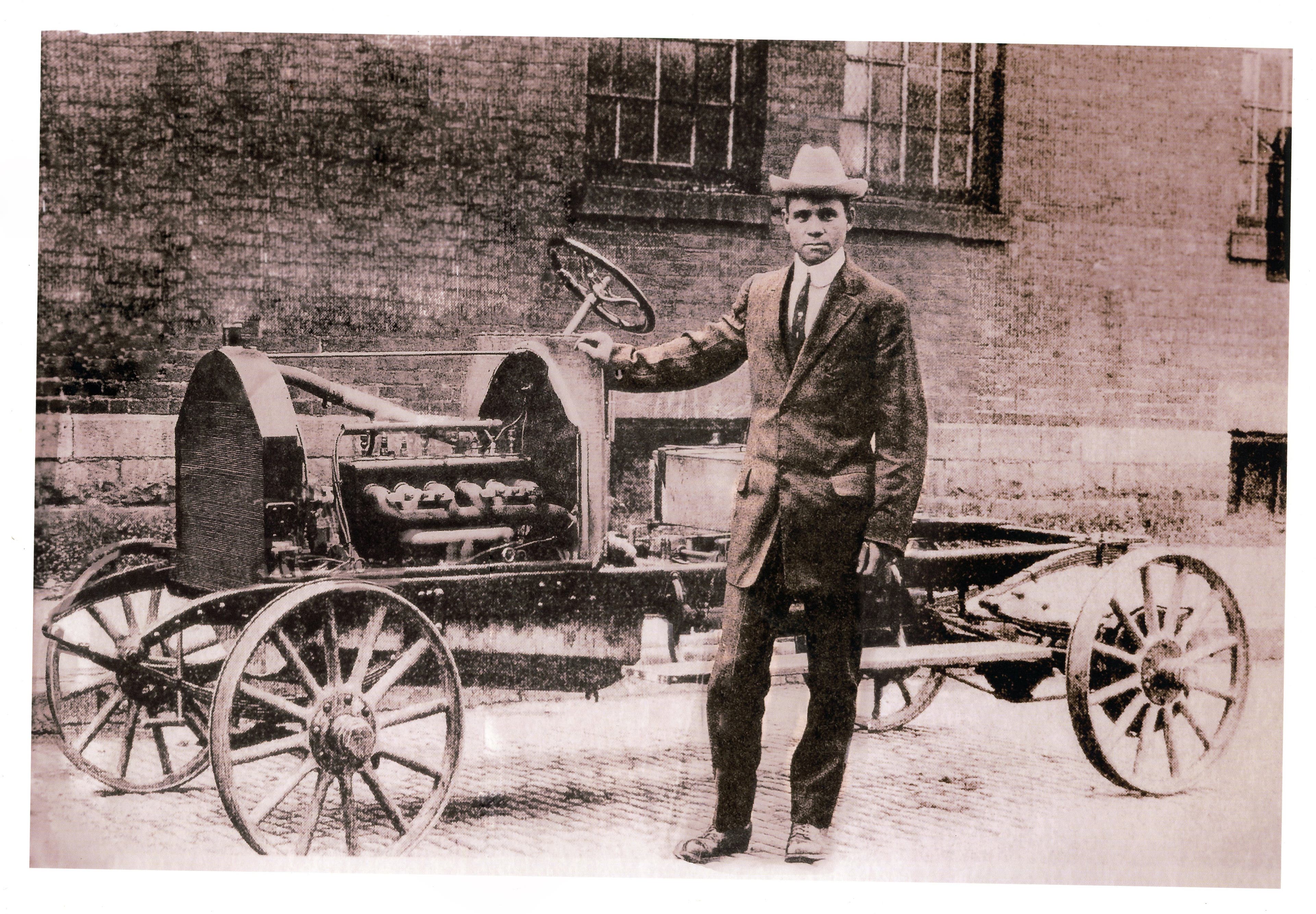 Frederick Patterson standing beside a bare Patterson-Greenfield automobile chassis, probably for a larger touring car body.